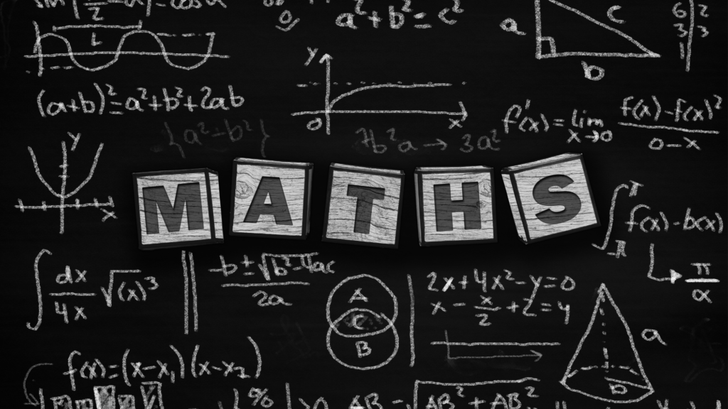 Holiday entitlement calculator: wooden letter blocks spelling MATHS on a blackboard covered in chalk equations and graphs