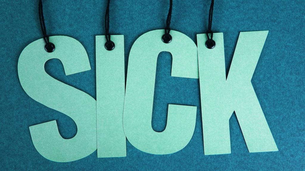 SSP changes April 2026: the word “SICK” in green card letters hanging on black string against a teal background